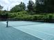 Tennis court with well-maintained surface, net, and backdrop of lush greenery, providing a recreational amenity at 3527 Essex Ave # 74, Atlanta, GA 30339