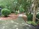 Outdoor walkway through landscaped grounds, enhanced by mulch, trees, and greenery at 3527 Essex Ave # 74, Atlanta, GA 30339