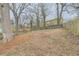 Backyard featuring mature trees, a mix of wood and chain link fence, with grass and underbrush at 403 Westchester Nw Blvd, Atlanta, GA 30314