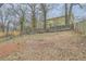 Large backyard enclosed by a combination of wood and chain link fencing with mature trees at 403 Westchester Nw Blvd, Atlanta, GA 30314