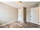 Bedroom featuring wood-look flooring, neutral walls, and two white doors at 403 Westchester Nw Blvd, Atlanta, GA 30314