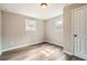 Bedroom with wood-look flooring, neutral walls, two windows and a white door at 403 Westchester Nw Blvd, Atlanta, GA 30314