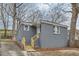 Charming one-story home with gray brick exterior, new wooden stairs and mature trees at 403 Westchester Nw Blvd, Atlanta, GA 30314