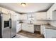 Bright kitchen with white cabinets, granite countertops, stainless steel refrigerator and hardwood floors at 403 Westchester Nw Blvd, Atlanta, GA 30314