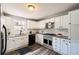 Bright open kitchen featuring white cabinets, stainless steel appliances and modern fixtures at 403 Westchester Nw Blvd, Atlanta, GA 30314