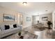 Staged living room with hardwood floors, soft gray sofa, coffee table, and round dining table at 403 Westchester Nw Blvd, Atlanta, GA 30314