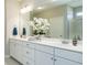 Bathroom with double vanity and white cabinets with large mirror and modern fixtures at 524 Lanier Way, Temple, GA 30179