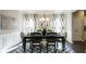 Elegant dining room featuring dark hardwood floors, black table and chairs, a chandelier and wainscoting at 524 Lanier Way, Temple, GA 30179