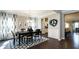 Elegant dining room features dark hardwood floors, black table and chairs, and wainscoting at 524 Lanier Way, Temple, GA 30179