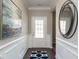 Inviting home hallway features a dark floor, white paneled walls, and an art piece, creating a welcoming ambiance at 524 Lanier Way, Temple, GA 30179