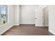 Neutral bedroom with hardwood floors, a bright window and a white door in a cozy setting at 897 Porches Way, Dacula, GA 30019