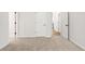 Bedroom featuring neutral carpet, white doors and open doorway to the hallway at 897 Porches Way, Dacula, GA 30019