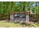 Community sign at The Porches at Mobley Lake surrounded by a wooden fence and lush greenery at 897 Porches Way, Dacula, GA 30019