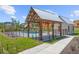 Community pool and pavilion with metal roof, black fencing and lush green landscaping at 897 Porches Way, Dacula, GA 30019