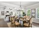 Elegant dining area with a coffered ceiling, natural light, stylish table setting, and open living area at 897 Porches Way, Dacula, GA 30019