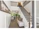 Bright foyer with high ceilings, a staircase with dark wood and metal railings, and a bench seat at 897 Porches Way, Dacula, GA 30019