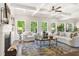 Bright living room featuring a fireplace, coffered ceiling, stylish furnishings, and large windows with natural light at 897 Porches Way, Dacula, GA 30019