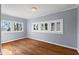 Bright bedroom featuring hardwood floors and a large window offering ample natural light at 135 Adair Se Ave, Atlanta, GA 30315