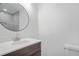 Bathroom features modern vanity with a round mirror, and tiled shower at 674 Valleyview Dr, Forest Park, GA 30297