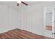 Bedroom with a ceiling fan, closet, and wood-look floors at 674 Valleyview Dr, Forest Park, GA 30297