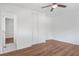 Bright bedroom features a ceiling fan, closet, and modern wood-look floors at 674 Valleyview Dr, Forest Park, GA 30297