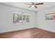 Bedroom with modern ceiling fan and large windows offering natural light at 674 Valleyview Dr, Forest Park, GA 30297