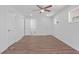 Bright main bedroom featuring light wood flooring, a ceiling fan, and access to an ensuite bathroom at 674 Valleyview Dr, Forest Park, GA 30297