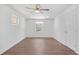 Light-filled main bedroom showcasing light wood flooring, a ceiling fan, and white walls for a serene atmosphere at 674 Valleyview Dr, Forest Park, GA 30297