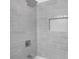 Modern shower with stylish gray tile, a niche, and a contemporary shower head at 674 Valleyview Dr, Forest Park, GA 30297