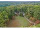 Expansive aerial view of a home nestled among lush, mature trees and a well-kept lawn and driveway at 6791 Yacht Club Dr, Acworth, GA 30102