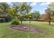 Well-maintained backyard with mature trees and a landscaped area at 6791 Yacht Club Dr, Acworth, GA 30102