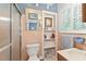 Quaint bathroom with a glass shower, toilet and a single sink featuring pink tile at 6791 Yacht Club Dr, Acworth, GA 30102