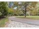 Scenic view of a winding driveway through a lush, wooded landscape at 6791 Yacht Club Dr, Acworth, GA 30102