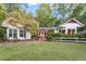 Charming home featuring a well-manicured lawn and a welcoming front porch with cozy seating at 6791 Yacht Club Dr, Acworth, GA 30102