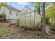 An outdoor greenhouse sits beside the home with adjacent trees and foliage at 6791 Yacht Club Dr, Acworth, GA 30102