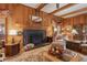 Living room with stone fireplace and wooden paneling at 6791 Yacht Club Dr, Acworth, GA 30102