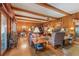 Cozy living room with wood-paneled walls, exposed beams, and a stone fireplace at 6791 Yacht Club Dr, Acworth, GA 30102