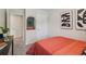 This bedroom has a red bed, dark art on the wall, and a view to a closet at 2284 Jamin Bnd # 18, Lithonia, GA 30058