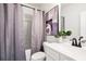 A simple bathroom with a tub/shower, lavender curtains, and a white sink at 2769 Porches Ln, Dacula, GA 30019