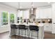 Modern kitchen with white cabinets, a large island, and stainless steel appliances at 2769 Porches Ln, Dacula, GA 30019