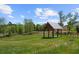 Community covered pavilion in open field with mature trees and view of lake at 2769 Porches Ln, Dacula, GA 30019