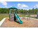 Well-maintained community playground with a slide, swings, and climbing features at 2769 Porches Ln, Dacula, GA 30019
