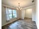 Bright dining area with a chandelier, luxury vinyl plank flooring, and lots of natural light at 4030 Rockcap Cv, Buford, GA 30519