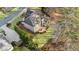 Aerial view of the backyard featuring a stone patio, spacious lawn, and lush landscaping at 406 Greyfield Dr, Canton, GA 30115