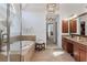 Bright bathroom featuring dual sinks, granite countertops, and a tiled shower and tub at 406 Greyfield Dr, Canton, GA 30115