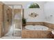 Bright bathroom showcasing a glass shower and soaking tub with tiled surround at 406 Greyfield Dr, Canton, GA 30115