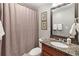 Well-lit bathroom with granite counters, framed mirror, and shower-tub combo at 406 Greyfield Dr, Canton, GA 30115