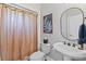 Charming bathroom featuring a pedestal sink, neutral shower curtain and elegant decorative touches at 406 Greyfield Dr, Canton, GA 30115