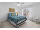 Comfortable bedroom with a ceiling fan and bright natural light from a large window at 406 Greyfield Dr, Canton, GA 30115
