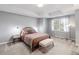 Comfortable bedroom features neutral colors, carpet, and large window with natural light at 406 Greyfield Dr, Canton, GA 30115